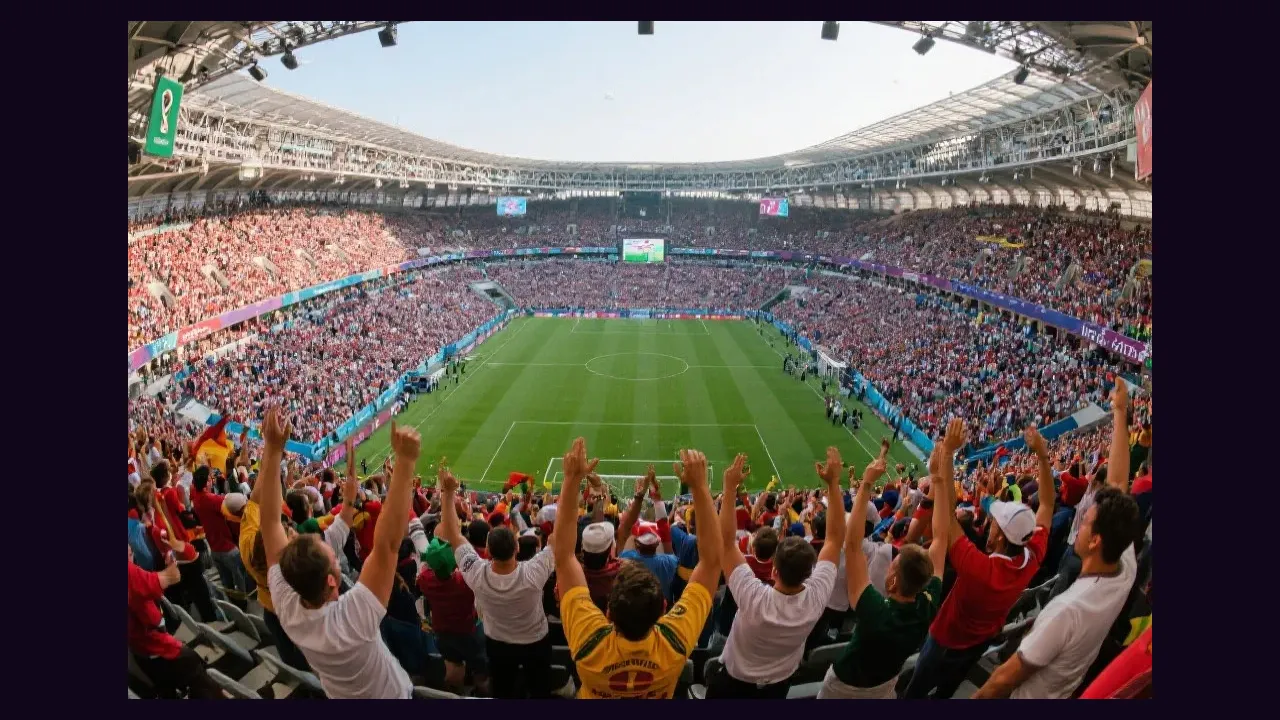 A packed football stadium with fans cheering during a match